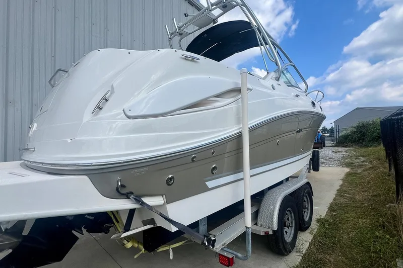Slide: The Image of 2007 Sea Ray 270 Amberjack boat on trailer, parked outdoors near a building. - 33