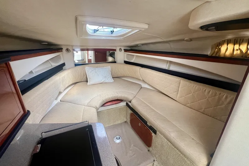 Slide: The Image of 2007 Sea Ray 270 Amberjack cabin interior with beige seating and overhead skylight. - 25