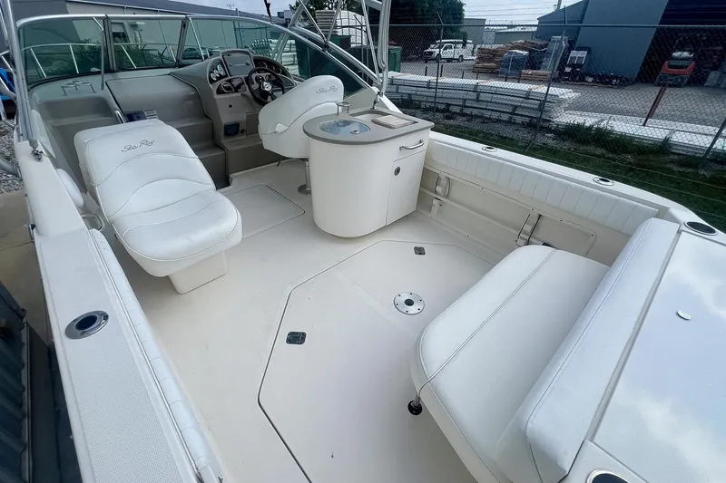 Slide: The Image of 2007 Sea Ray 270 Amberjack boat interior with white seating and helm station. - 6