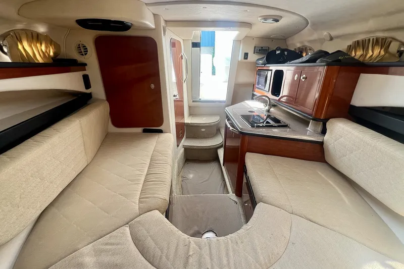 Slide: The Image of Interior of 2007 Sea Ray 270 Amberjack boat with cozy seating and kitchenette. - 28