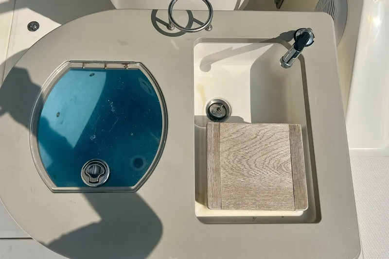 Slide: The Image of 2007 Sea Ray 270 Amberjack boat sink and cutting board setup. - 13