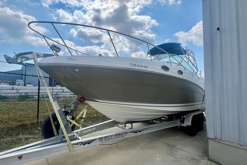 Slide: The Image of 2007 Sea Ray 270 Amberjack boat on trailer, parked outdoors under a cloudy sky. - 32