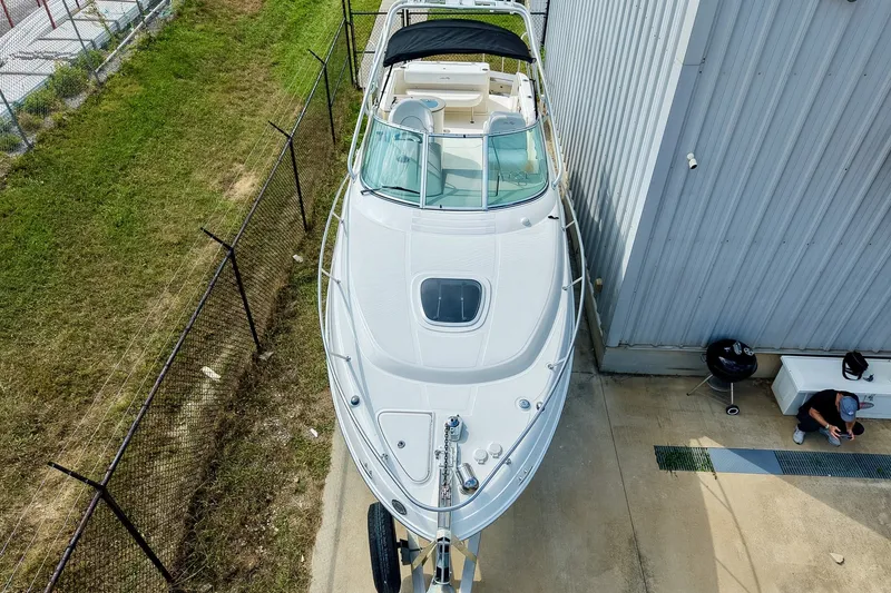 Slide: The Image of 2007 Sea Ray 270 Amberjack boat parked beside a building, viewed from above. - 21