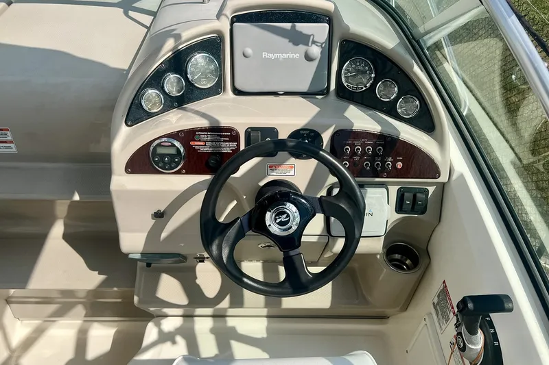 Slide: The Image of Dashboard of a 2007 Sea Ray 270 Amberjack boat with steering wheel and gauges. - 15