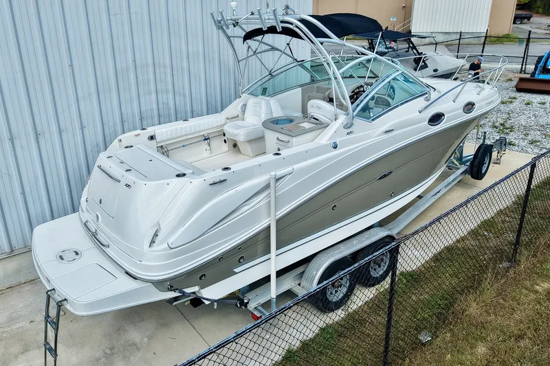Slide: The Image of 2007 Sea Ray 270 Amberjack boat on trailer, parked outdoors near a metal building. - 39