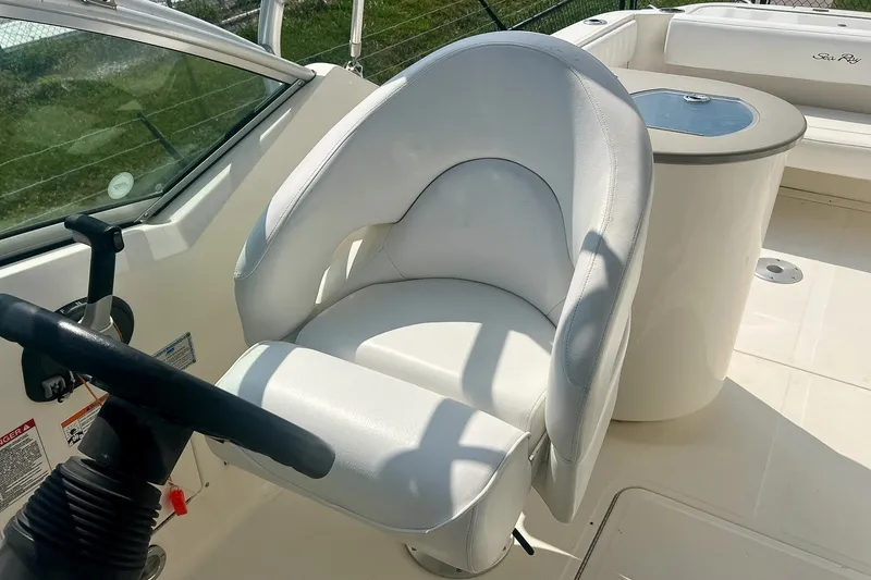 Slide: The Image of Captain's seat on 2007 Sea Ray 270 Amberjack boat, featuring sleek white upholstery. - 17