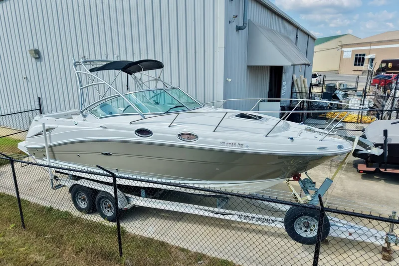 Slide: The Image of 2007 Sea Ray 270 Amberjack boat on trailer near industrial building. - 0