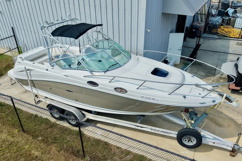 Slide: The Image of 2007 Sea Ray 270 Amberjack boat on trailer, parked near a metal building. - 41