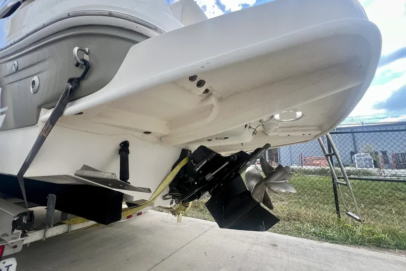 Slide: The Image of 2007 Sea Ray 270 Amberjack boat stern with propeller and ladder, parked on concrete. - 35