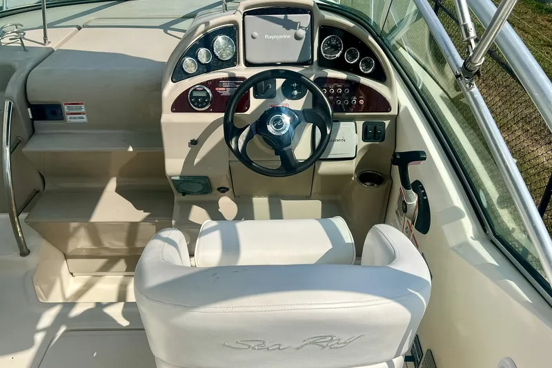 Slide: The Image of 2007 Sea Ray 270 Amberjack helm with steering wheel and navigation instruments. - 14