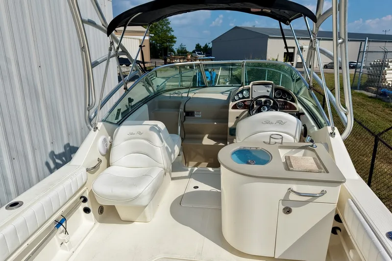 Slide: The Image of 2007 Sea Ray 270 Amberjack boat interior with helm, seating, and kitchenette. - 7