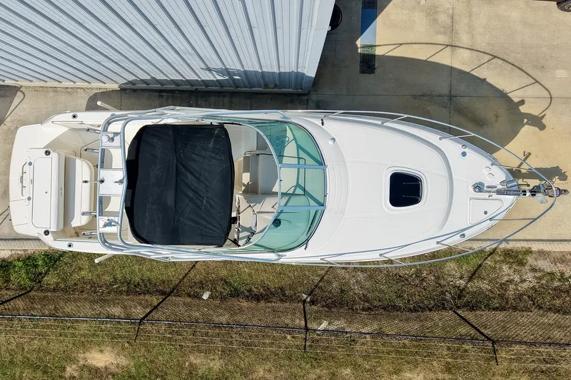 Slide: The Image of Overhead view of a 2007 Sea Ray 270 Amberjack boat docked beside a building. - 2