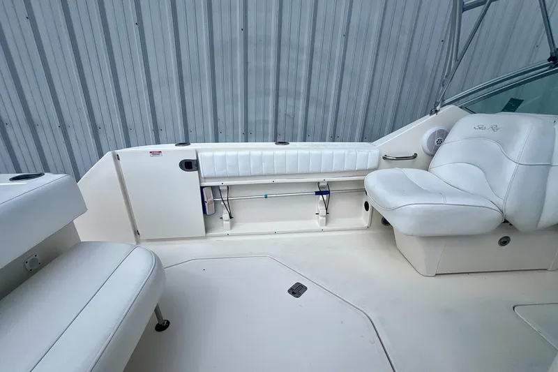 Slide: The Image of 2007 Sea Ray 270 Amberjack boat interior with white seating and storage compartments. - 9