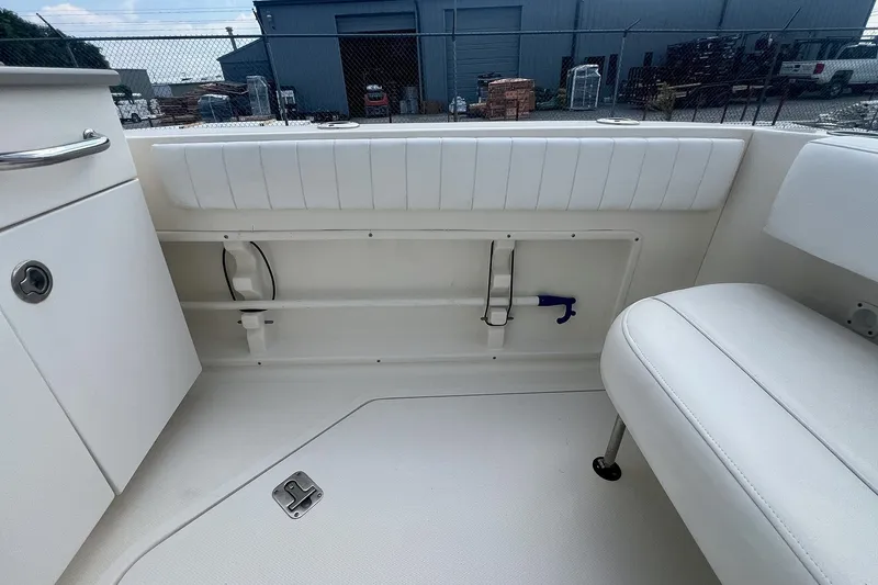 Slide: The Image of Interior view of a 2007 Sea Ray 270 Amberjack boat, featuring white seating and storage. - 10