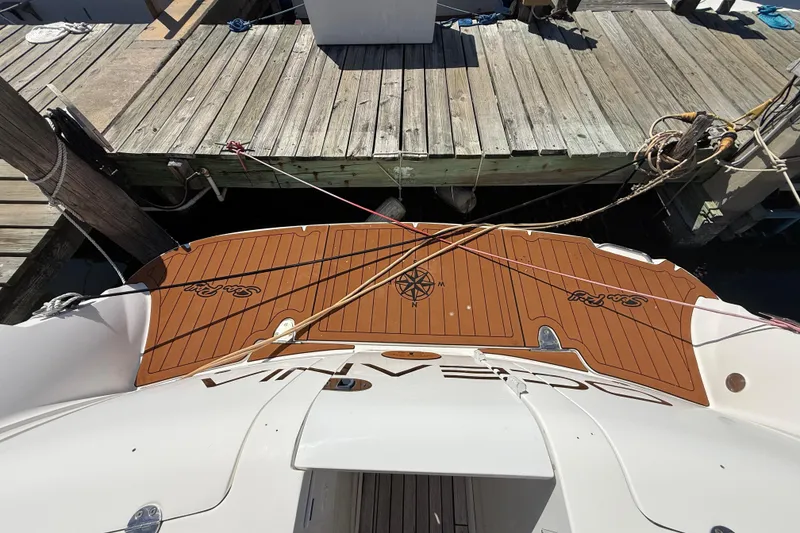 Slide: The Image of 2008 Sea Ray 38 Sundancer docked, showcasing teak swim platform and nautical compass design. - 136