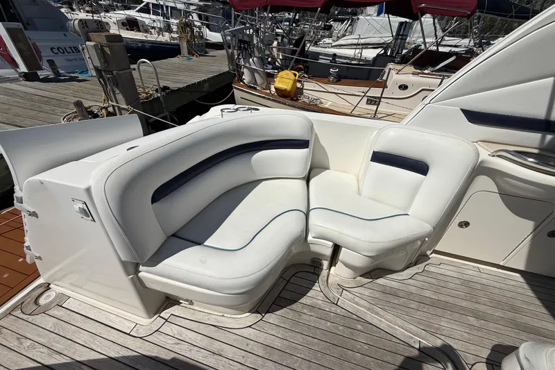 Slide: The Image of Luxury seating on a 2008 Sea Ray 38 Sundancer yacht, docked at a marina. - 130