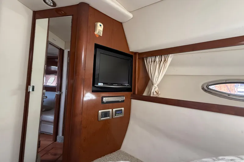 Slide: The Image of Interior of 2008 Sea Ray 38 Sundancer yacht with TV and wood paneling. - 46