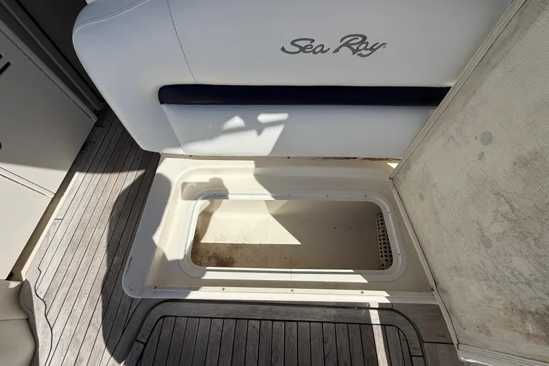 Slide: The Image of Open storage compartment on 2008 Sea Ray 38 Sundancer boat with wooden deck. - 139