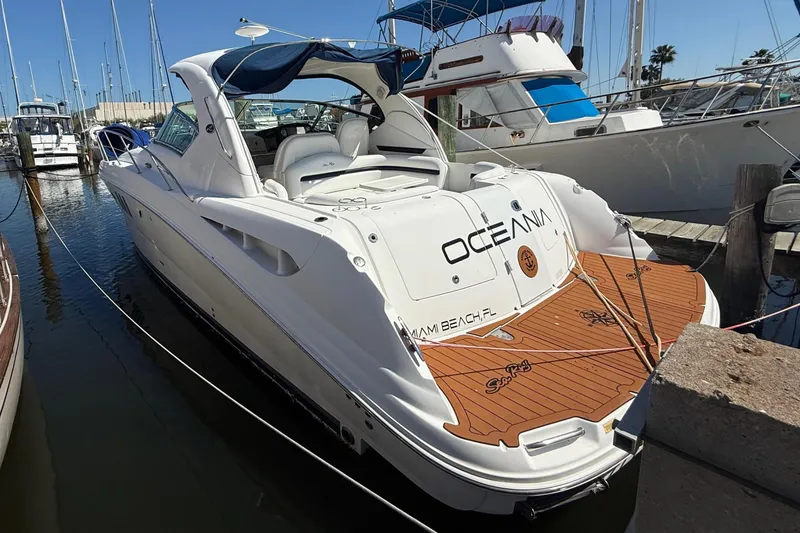 Slide: The Image of 2008 Sea Ray 38 Sundancer yacht docked at marina, featuring sleek design and spacious deck. - 2