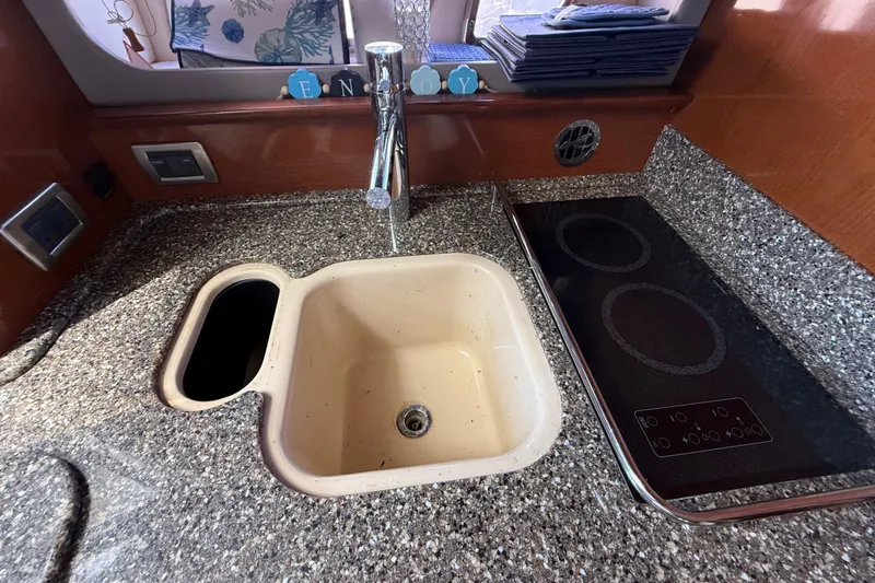 Slide: The Image of Galley kitchen in 2008 Sea Ray 38 Sundancer with sink and stovetop. - 63