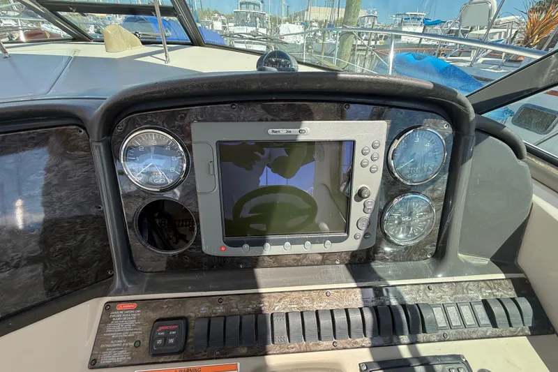 Slide: The Image of Dashboard of a 2008 Sea Ray 38 Sundancer boat with navigation instruments. - 102