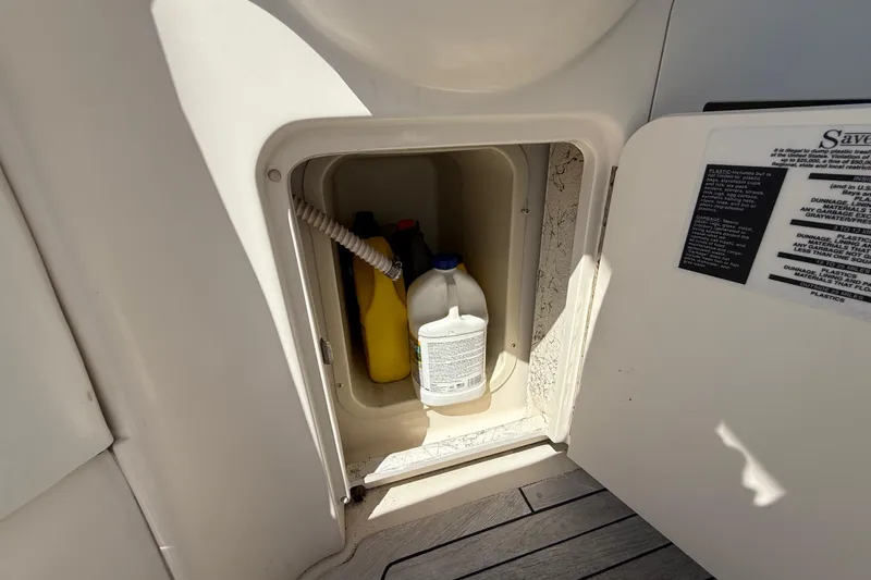 Slide: The Image of Storage compartment on a 2008 Sea Ray 38 Sundancer boat with cleaning supplies. - 124