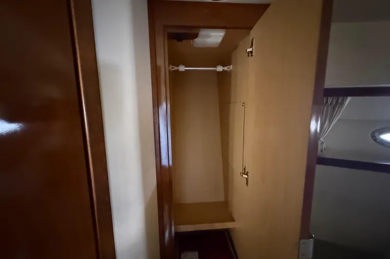 Slide: The Image of Open wooden closet inside 2008 Sea Ray 38 Sundancer yacht cabin. - 39