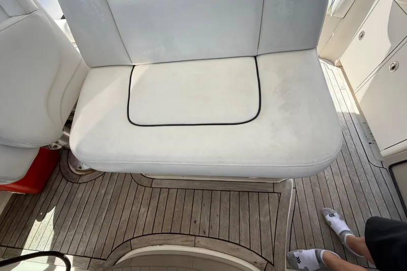 Slide: The Image of White seating on 2008 Sea Ray 38 Sundancer boat with wooden deck flooring. - 110