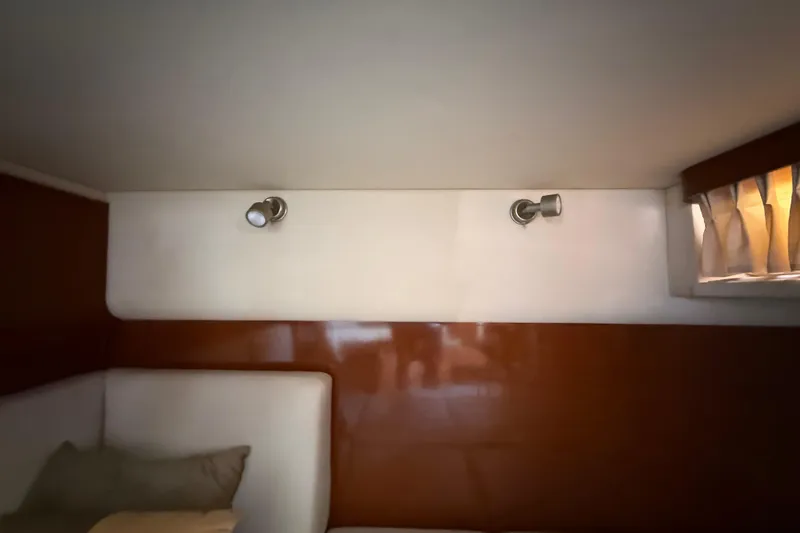 Slide: The Image of Interior cabin of 2008 Sea Ray 38 Sundancer with wall lights and window curtain. - 92