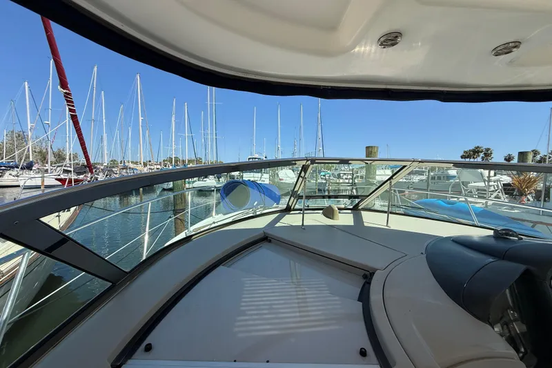 Slide: The Image of 2008 Sea Ray 38 Sundancer yacht docked at marina with sailboats in background. - 98
