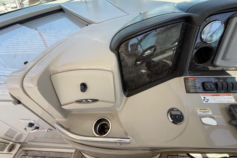 Slide: The Image of 2008 Sea Ray 38 Sundancer helm with controls and gauges, featuring sleek design. - 100