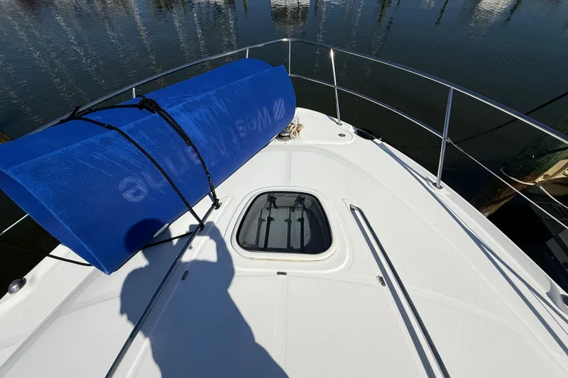 Slide: The Image of 2008 Sea Ray 38 Sundancer boat deck with blue mat and water reflection. - 15