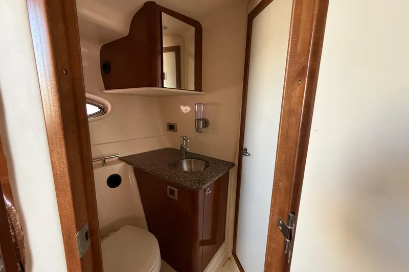 Slide: The Image of 2008 Sea Ray 38 Sundancer bathroom with wood accents and compact sink. - 88