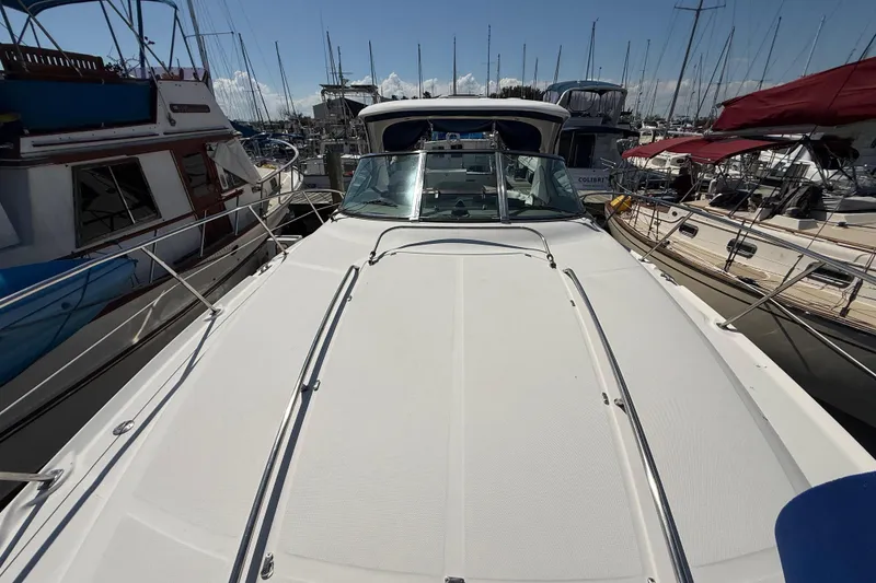 Slide: The Image of 2008 Sea Ray 38 Sundancer yacht docked in a marina, surrounded by other boats. - 9