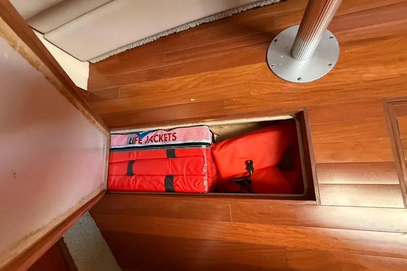 Slide: The Image of Life jackets stored in a compartment on a 2008 Sea Ray 38 Sundancer boat. - 75