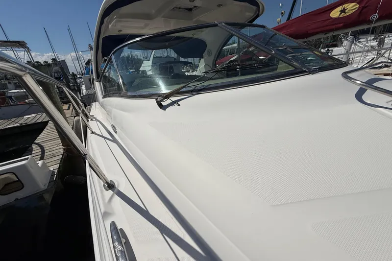Slide: The Image of 2008 Sea Ray 38 Sundancer yacht docked at marina, showcasing sleek design and windshield. - 22