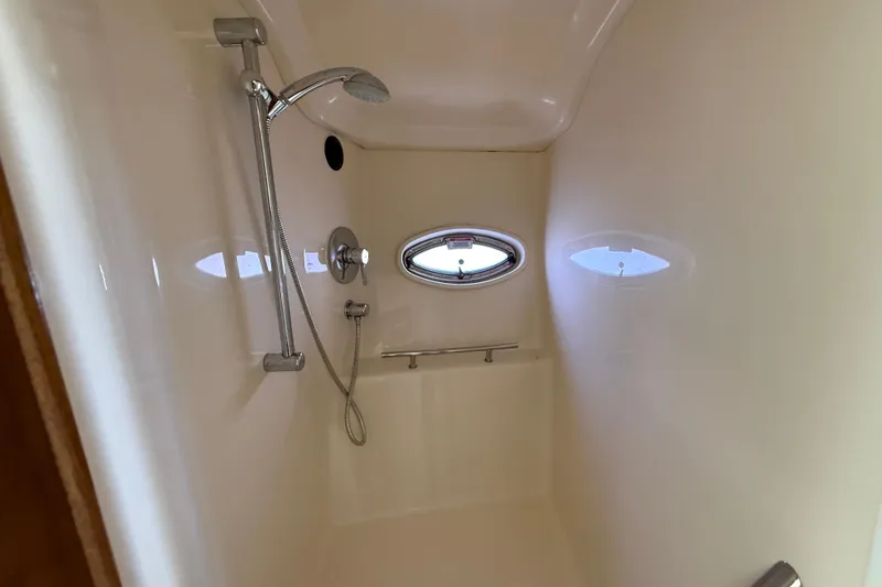 Slide: The Image of Shower area inside 2008 Sea Ray 38 Sundancer yacht, featuring sleek design and porthole window. - 52