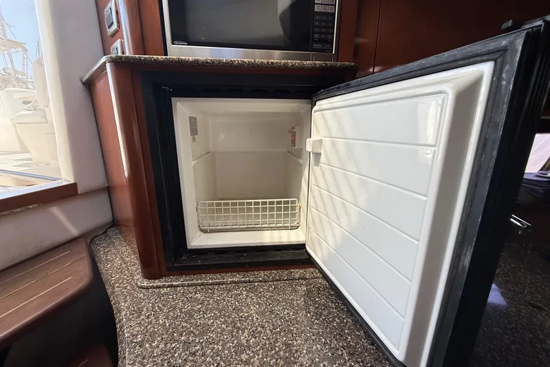 Slide: The Image of Open refrigerator in 2008 Sea Ray 38 Sundancer yacht kitchen, showcasing interior space. - 67