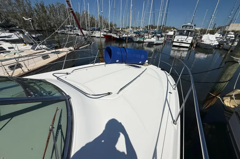 Slide: The Image of 2008 Sea Ray 38 Sundancer yacht docked in a marina with other boats. - 19