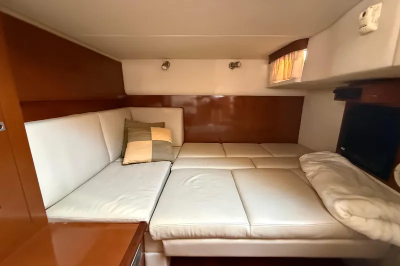 Slide: The Image of Interior cabin of 2008 Sea Ray 38 Sundancer with white seating and cushions. - 76