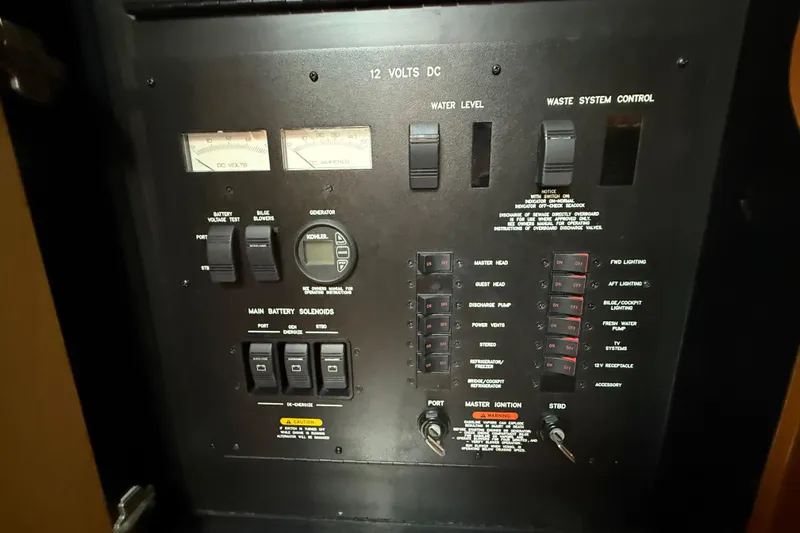 Slide: The Image of Control panel of a 2008 Sea Ray 38 Sundancer boat, featuring various switches and gauges. - 82