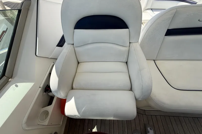 Slide: The Image of Captain's chair on 2008 Sea Ray 38 Sundancer yacht, featuring white upholstery and wooden deck. - 114