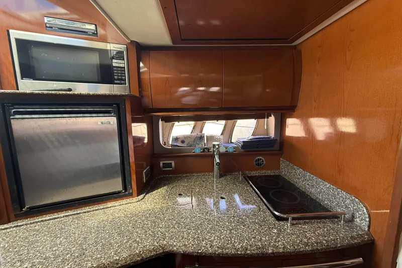 Slide: The Image of Luxurious kitchen area in a 2008 Sea Ray 38 Sundancer yacht with modern appliances. - 61