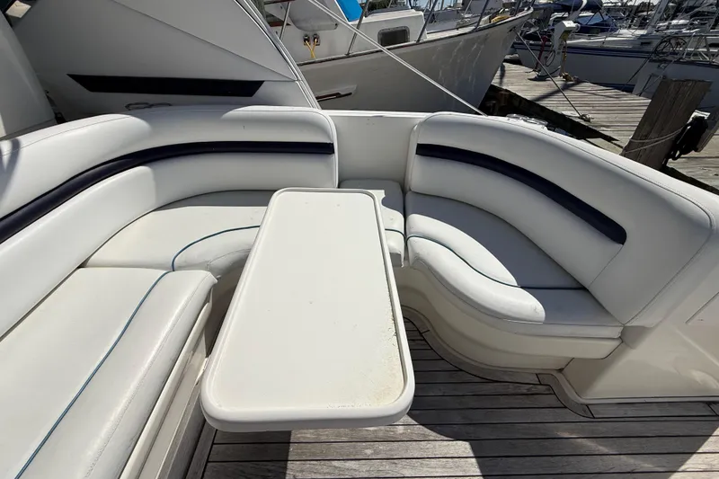 Slide: The Image of 2008 Sea Ray 38 Sundancer yacht seating area with white cushions and table. - 127