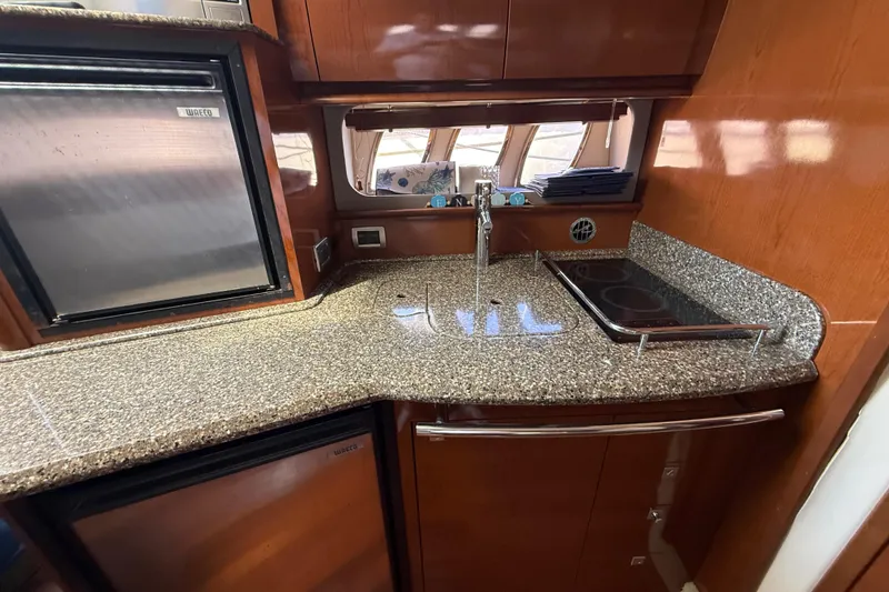 Slide: The Image of Luxurious 2008 Sea Ray 38 Sundancer yacht kitchen with granite countertops and modern appliances. - 60