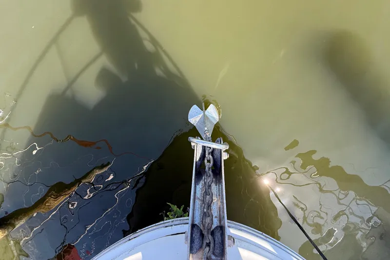 Slide: The Image of Bow view of 2008 Sea Ray 38 Sundancer with anchor over murky water. - 12