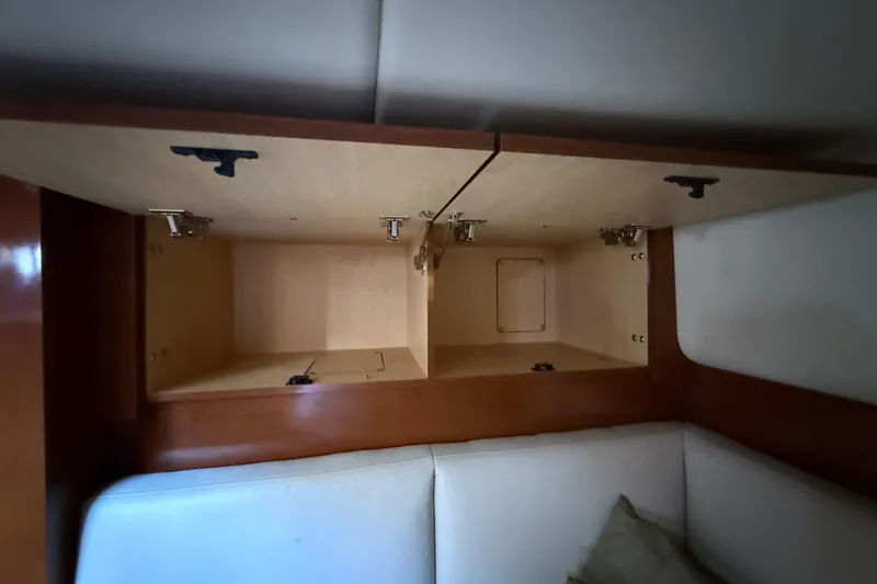 Slide: The Image of Open wooden storage cabinets inside a 2008 Sea Ray 38 Sundancer yacht. - 80