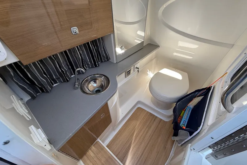 Slide: The Image of 2013 Formula 310 Bowrider bathroom with sink, toilet, and wood accents. - 41