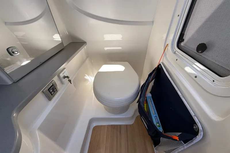Slide: The Image of 2013 Formula 310 Bowrider bathroom interior with toilet and storage compartment. - 43