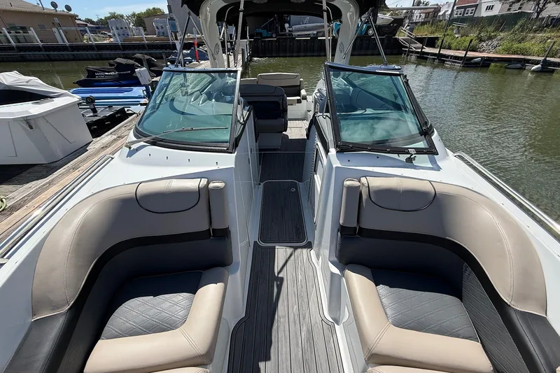 Slide: The Image of 2013 Formula 310 Bowrider interior with seating, docked by the water. - 49
